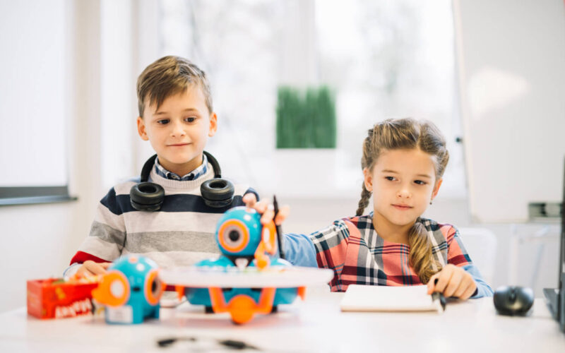 portrait-little-boy-looking-girl-playing-with-robotic-toy (1)